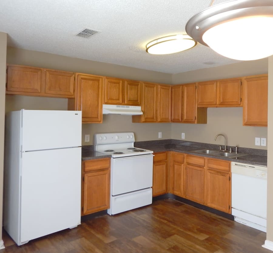 Kitchen with white appliances at Cypress Creek Townhomes in Goodlettsville, Tennessee
