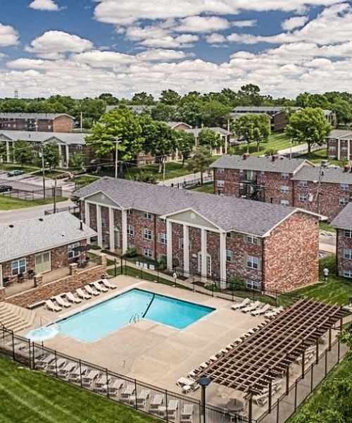 Exterior view of the building and pool at Columbia Crossing Apartments in Columbia, Missouri