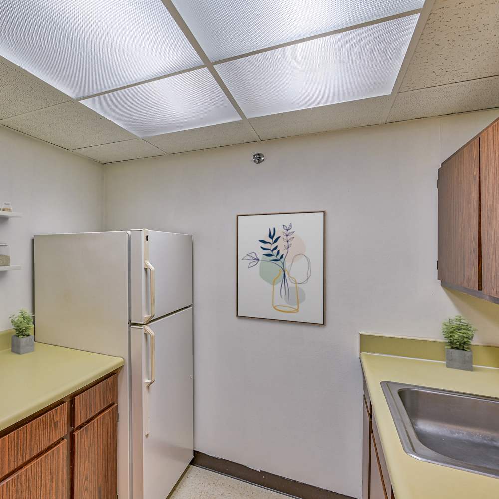 Model kitchen room with wood cabinets at The Grove in Ontario, California