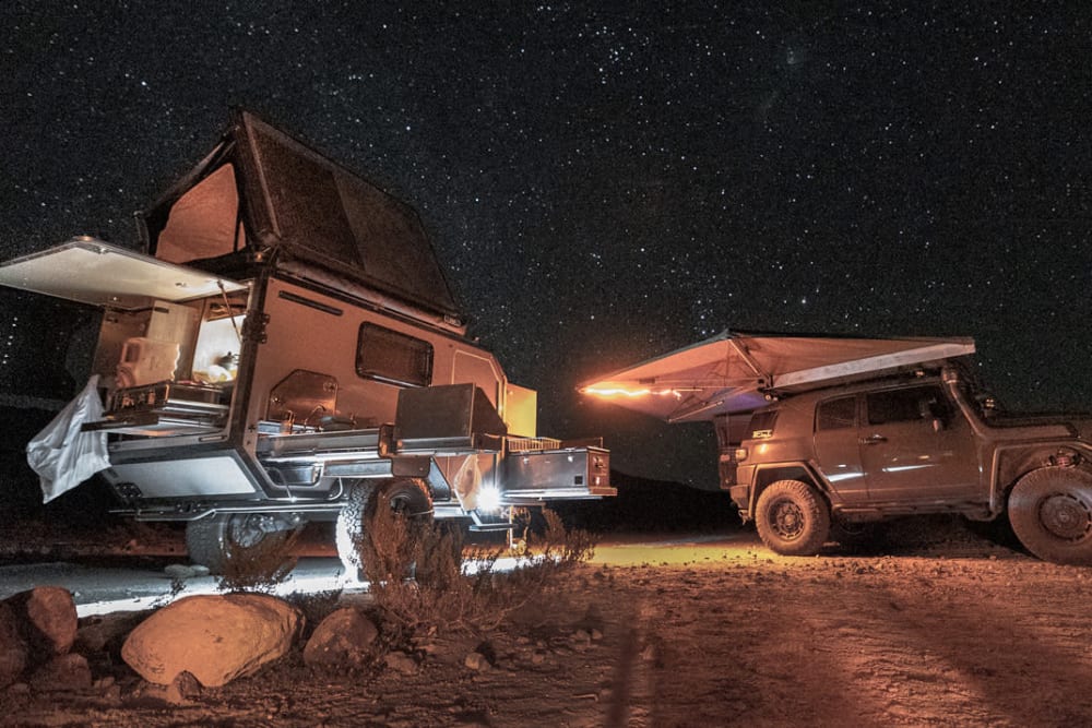 StorQuest Self Storage guest Adventure ATX Rentals camper and SUV under evening stars
