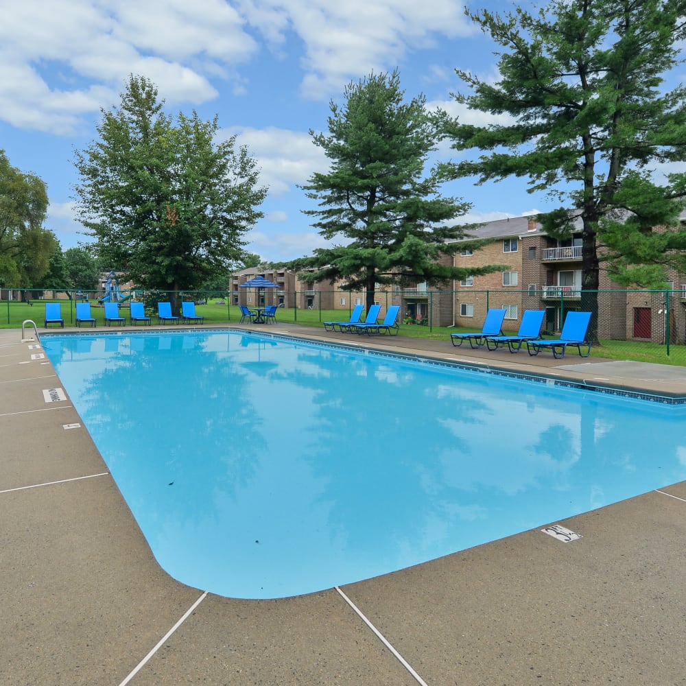 Swimming pool with lounge seating at Montgomery Woods Townhomes in Harleysville, Pennsylvania