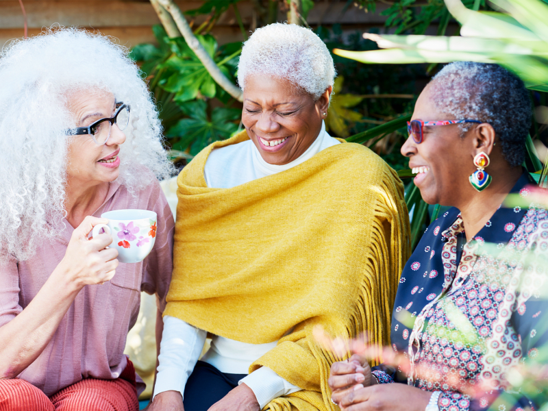 Residents sitting outside and laughing at Leisure Living Lakeside in Evansville, Indiana