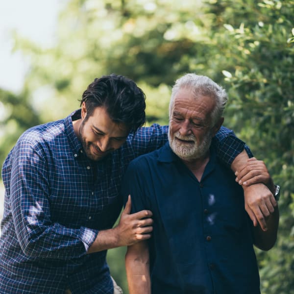 A resident and his son taking a stroll at Chesapeake Place Senior Living in Chesapeake, Virginia.