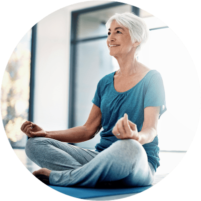 Resident sitting cross-legged doing yoga at The Spring at Silverton in Fort Worth, Texas