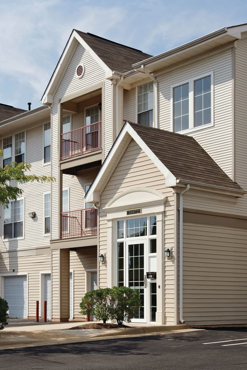 Exterior of Village at Potomac Falls Apartment Homes on a sunny spring day in Sterling, Virginia