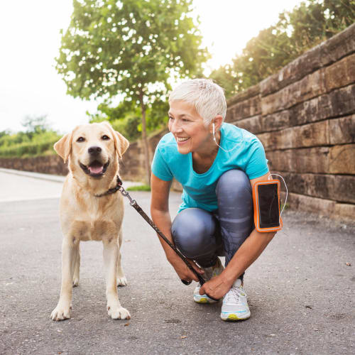 Happy dog and her owner about to go for a jog near The Ranch at Shadow Lake in Houston, Texas