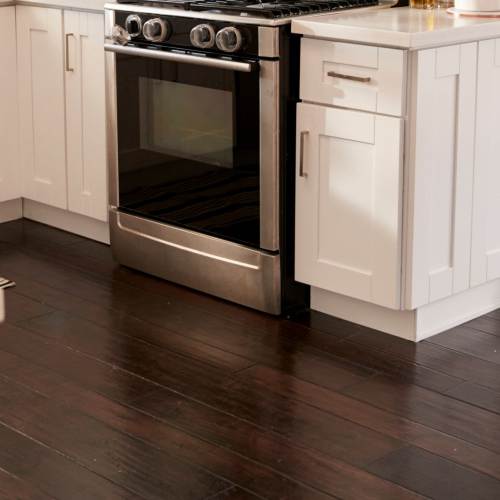Apartment kitchen with wood-style flooring at The Waters at Freeport in Freeport,Florida