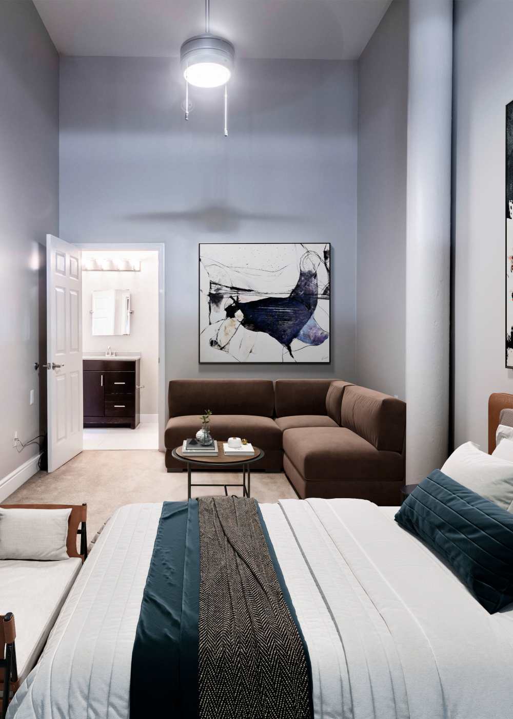 A furnished main bedroom with an attached bathroom at Broadway Apartments in Richmond, Virginia