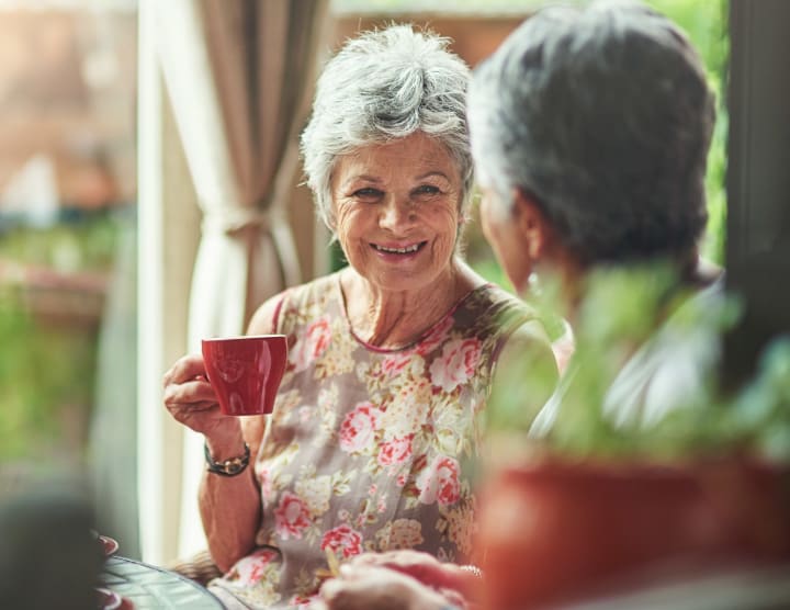 Senior women drinking coffee together