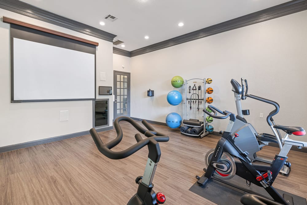 Spacious exercise room with equipment at Marquis at Kingwood in Kingwood, Texas