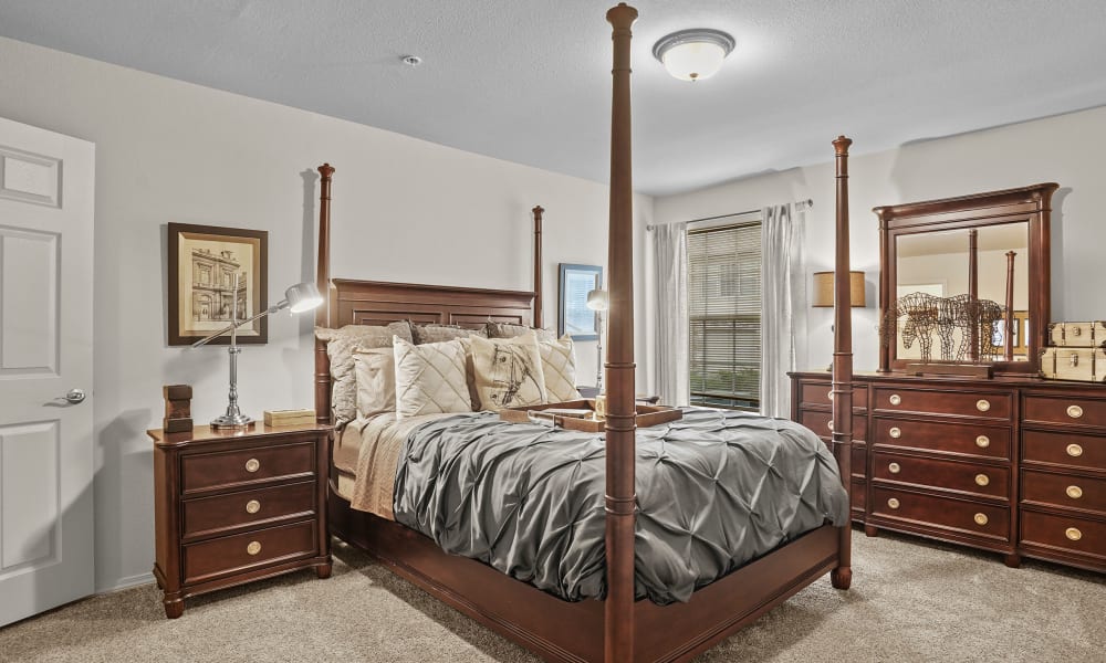 Cozy master bedroom with ceiling fan at Villas of Waterford Apartments in Wichita, Kansas
