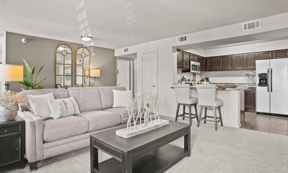 Spacious living room with plush carpeting at Mission Point Apartments in Moore, Oklahoma