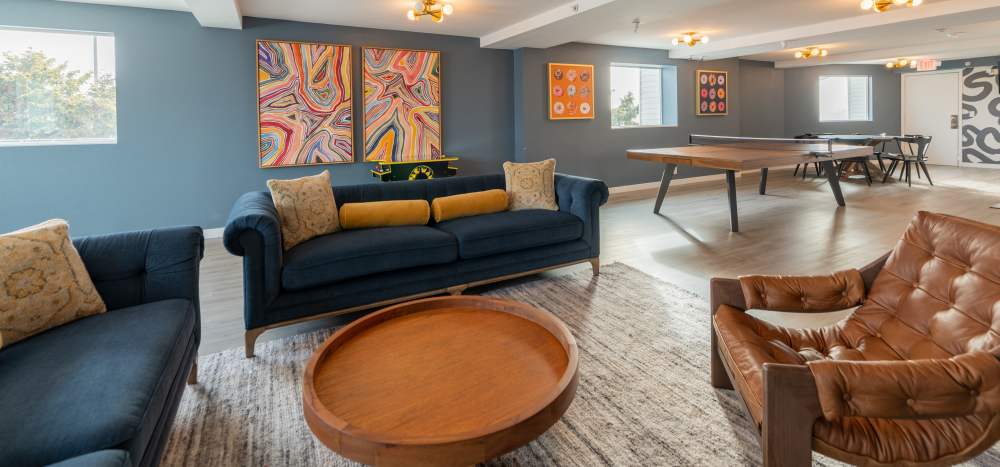Resident clubhouse lounge with games and wifi at  Thea Apartments in Tacoma, Washington