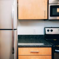 Kitchen with refrigerator at Courtyard Lofts at Scott’s Addition in Richmond, Virginia