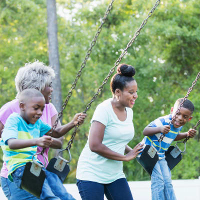 Resident children and their parents playing at a playground at Perry Circle Apartments in Annapolis, Maryland