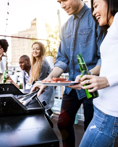 Friends grilling hot dogs at Kinect @ Broadway in Everett, Washington