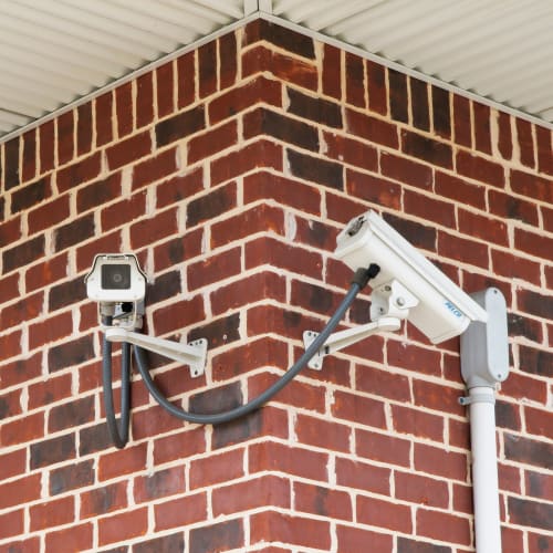 Security cameras mounted on a brick wall at Red Dot Storage in Vicksburg, Mississippi