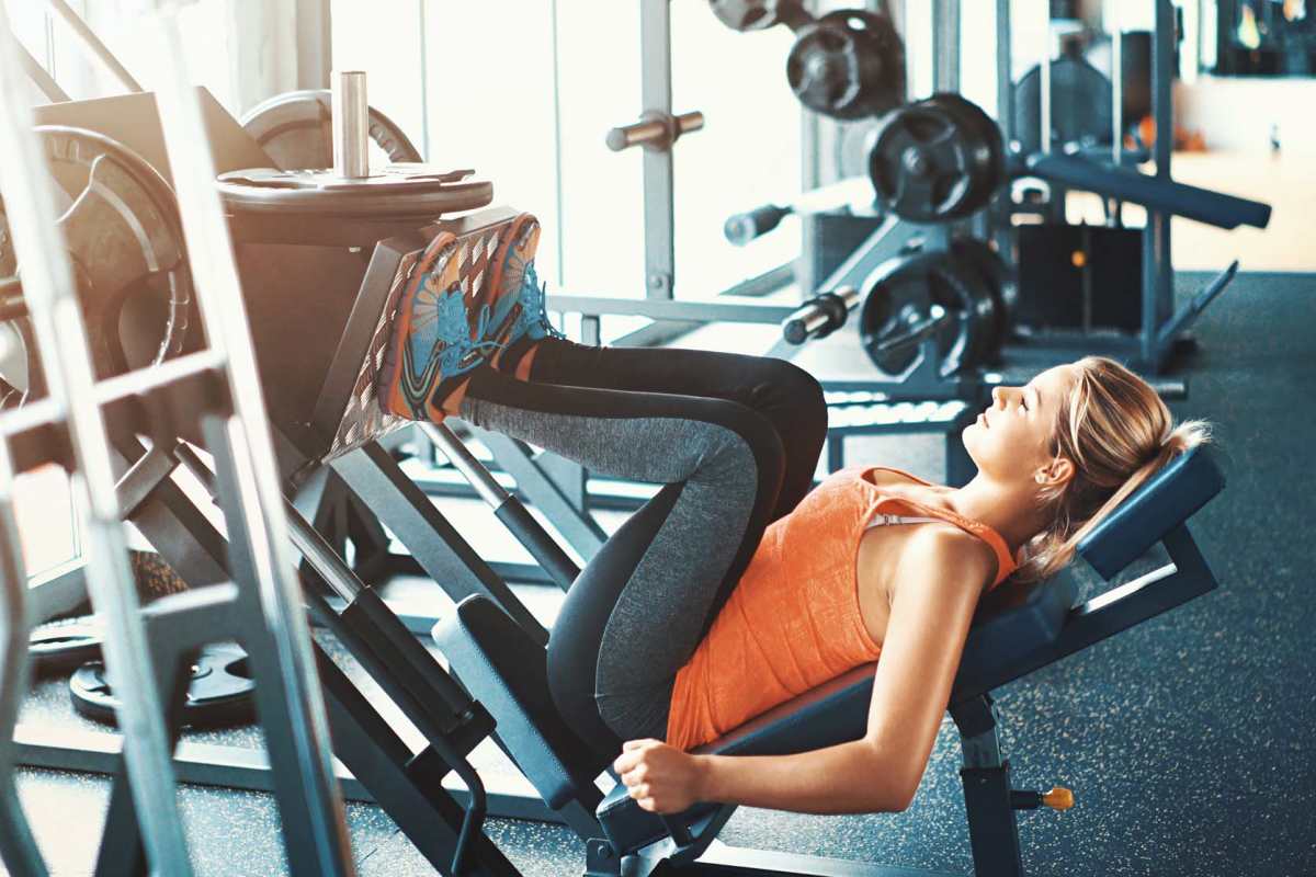 Resident woman doing workouts in the fitness center at Fairway Breeze in El Reno, Oklahoma