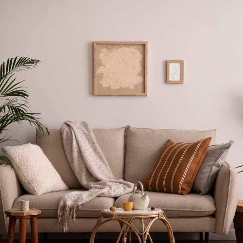 A cozy living room featuring a couch, coffee table, and a plant, located at Granite Creek in Rocklin, California.