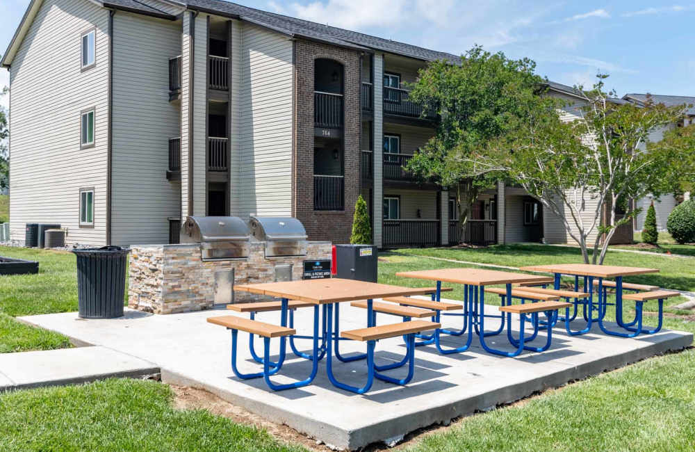 Outdoor grill area with picnic tables at Gable Oaks Apartment Homes in Rock Hill, South Carolina