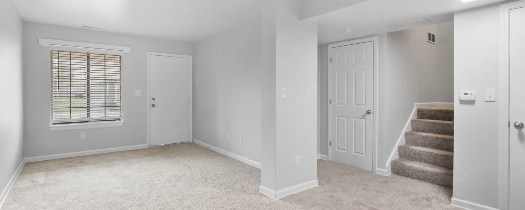 View of an empty living room space in an apartment at Eagle's Edge in Indianapolis 