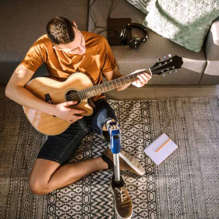 A resident plays his guitar in his apartment at CovePointe at The Landings, Norfolk, Virginia