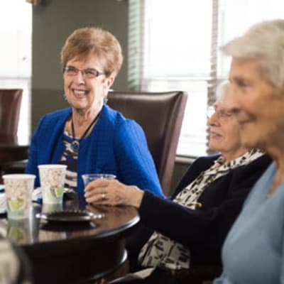 Residents sitting at a table talking over breakfast at Meadows on Fairview in Wyoming, Minnesota