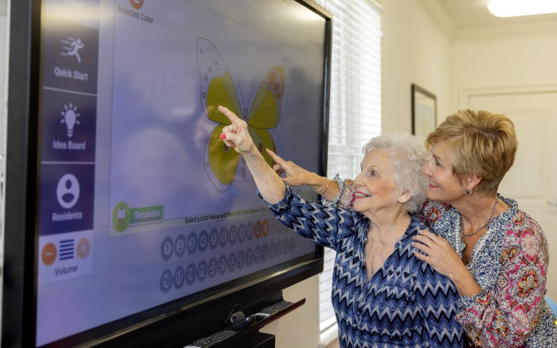 Caretaker doing a crossword with a resident at a QSL Management community