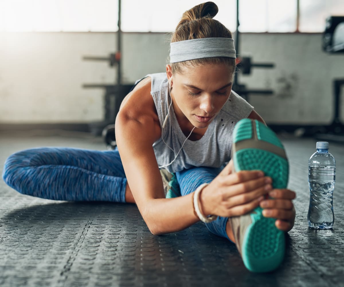 Woman stretching at Mission Point Apartments' fitness center in Moore, Oklahoma
