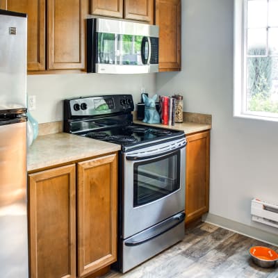 Modern kitchen with stainless-steel appliances in a model home at Sofi at Cedar Mill in Portland, Oregon