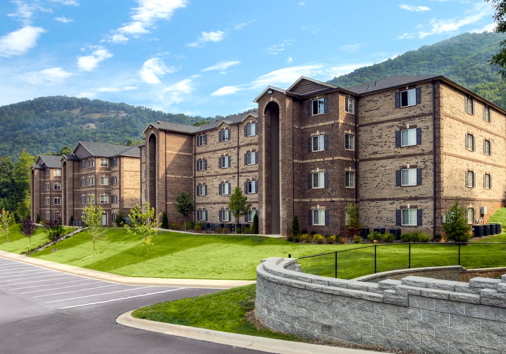 Exterior of apartment community with a mountain view at Berrington Village in Asheville, North Carolina