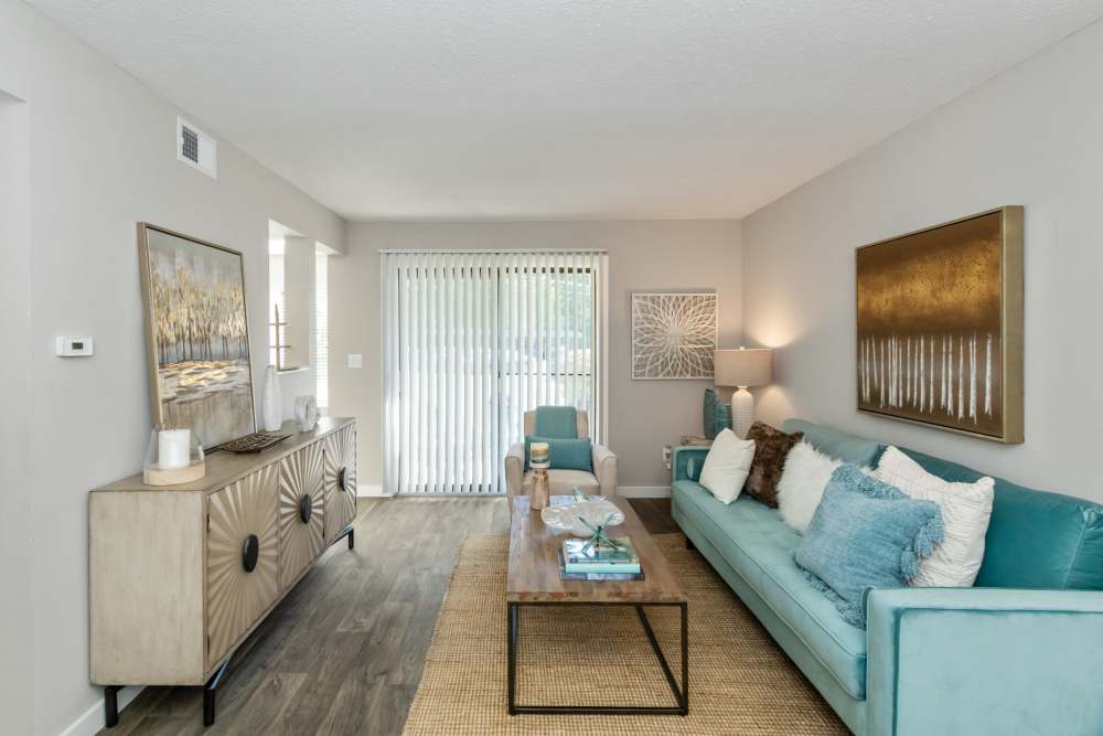 Living room of a model home with wood-style flooring at Parkside at Castleton Square in Indianapolis, Indiana