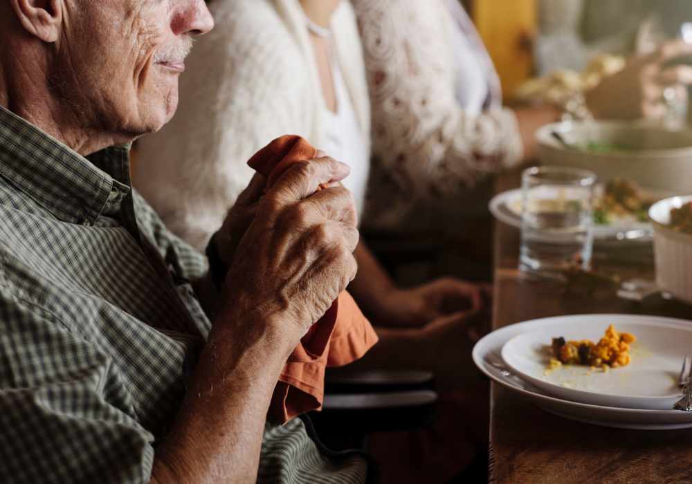 Senior man enjoying a meal at Clearwater at The Arboretum in Austin, Texas