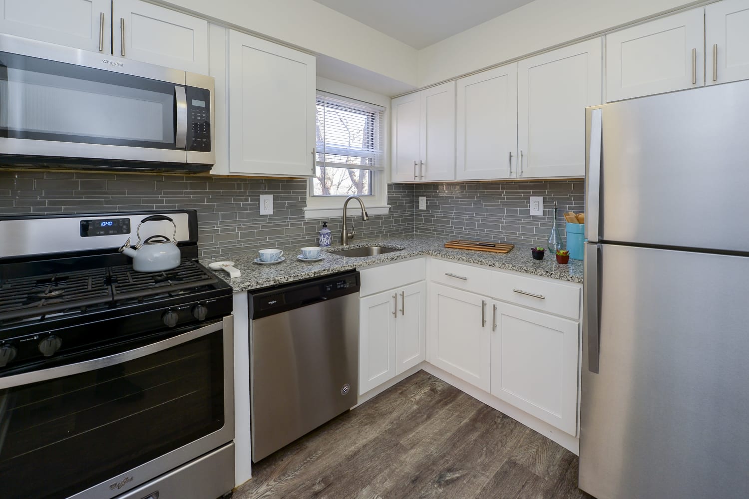 Kitchen with stainless-steel appliances and white cabinet at Mt. Arlington Gardens Apartment Homes in Mt. Arlington, New Jersey