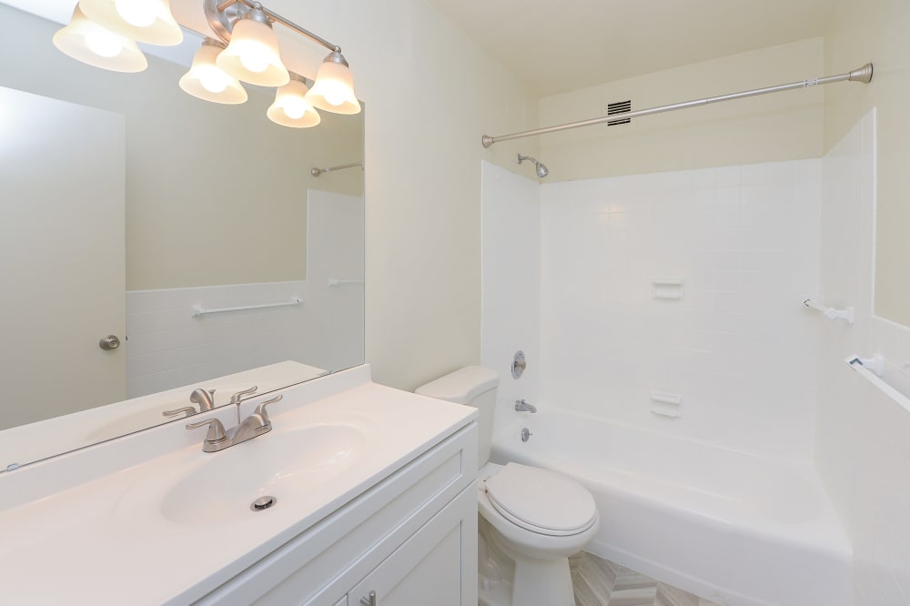 Upgraded bathroom with white vanity and bathtub