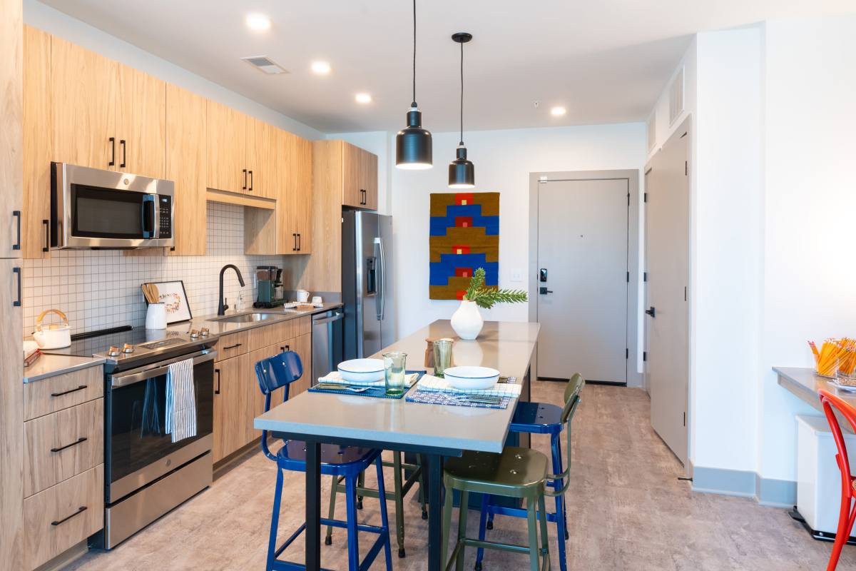 Apartment dining room and kitchen decorated in primary colors at Platform in Raleigh, North Carolina
