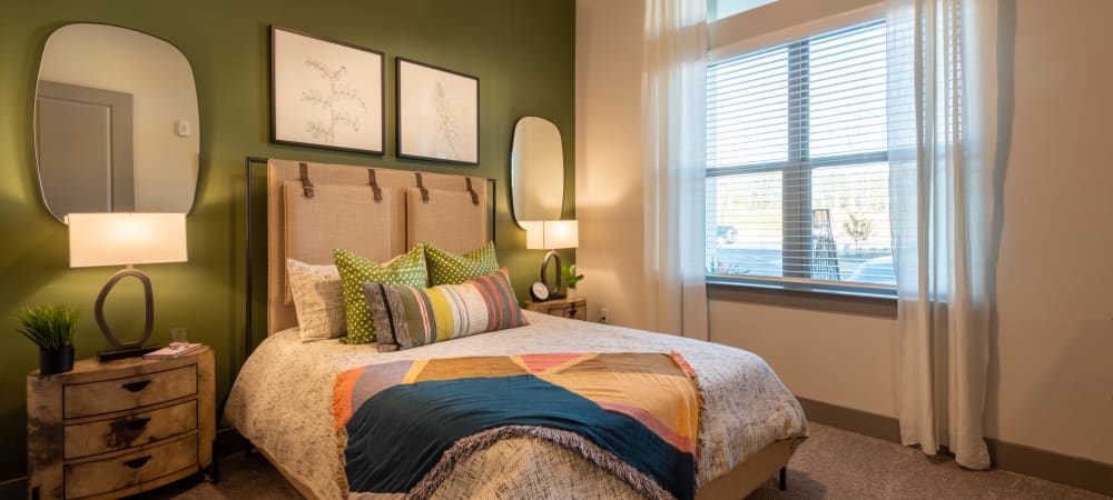 Well lit carpeted bedroom in a model home at The Reserve at Patterson Place in Durham, North Carolina