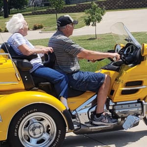 Resident Ida riding on a motorcycle near Emery Place in Robins, Iowa.