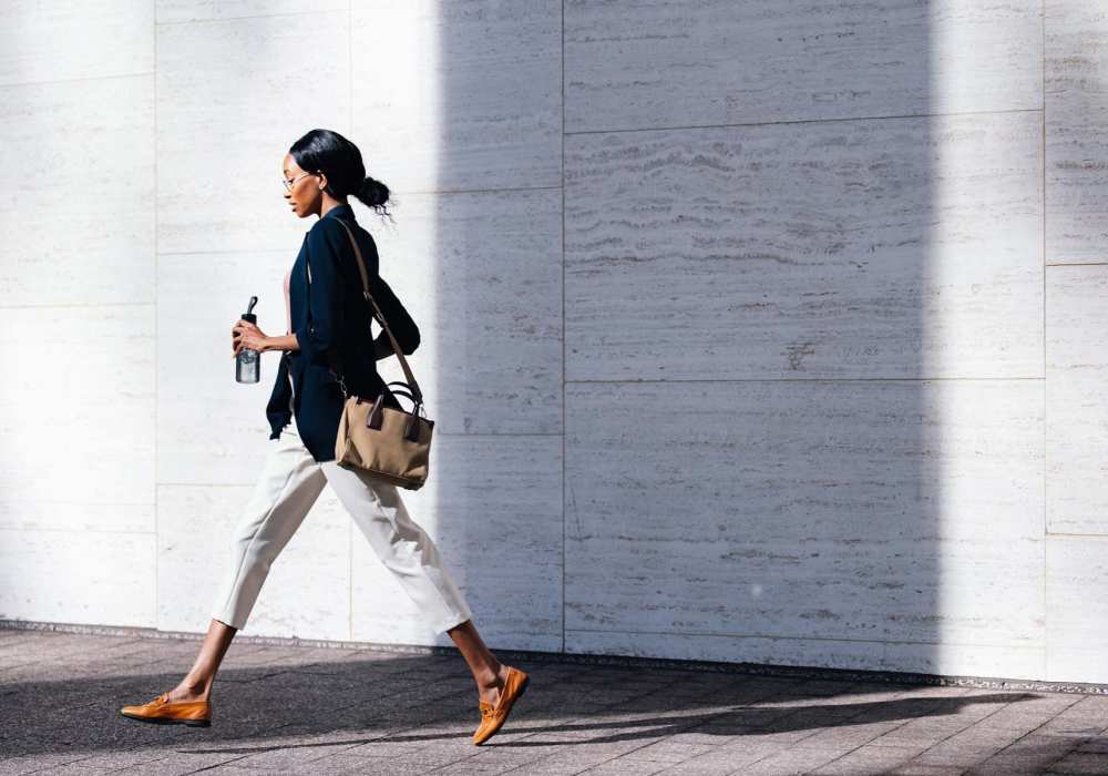Resident walking along a city street near North Road Townhomes in Scottsville, New York