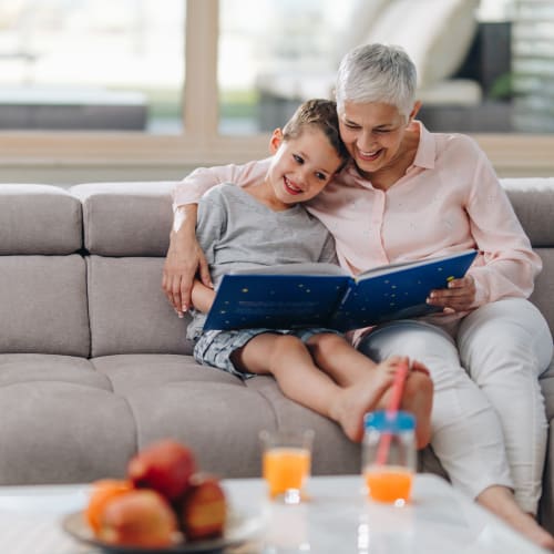 A grandmother reading a story with kid at Ben Moreell in Norfolk, Virginia