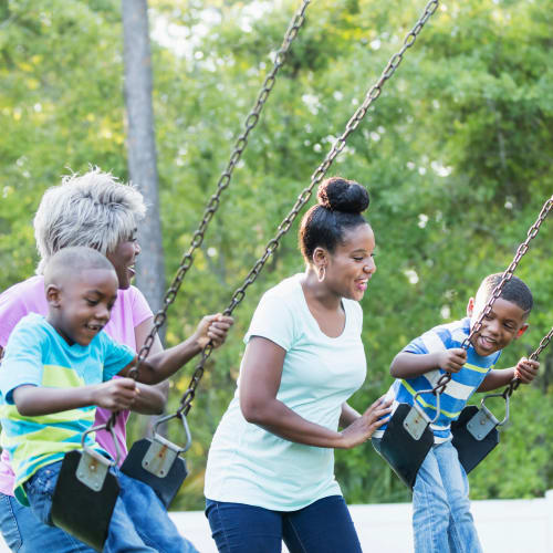 A resident family on a swingset at a local park near Capeharts in Ridgecrest, California