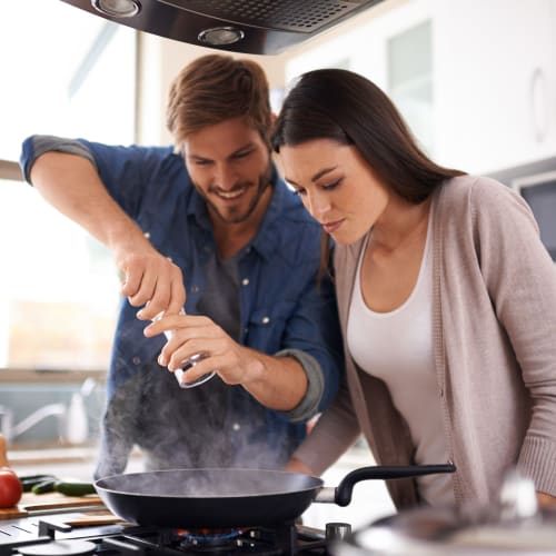 Residents cooking a meal in a home at Osprey Point in Virginia Beach, Virginia