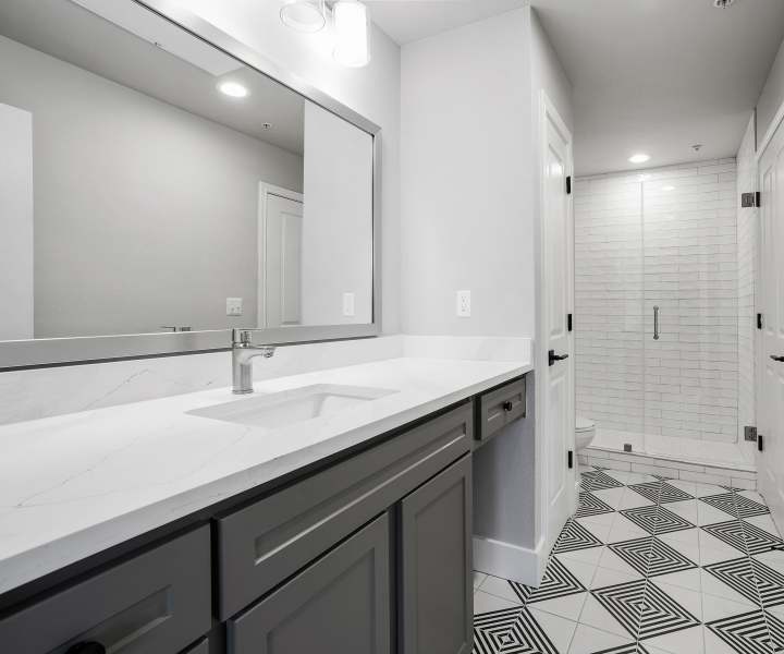 Bathroom with vanity mirror at The Fitz in Houston, Texas