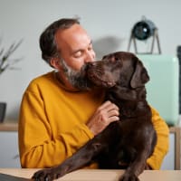 A resident giving his dogs snout a kiss at The Station at Brighton in Grovetown, Georgia