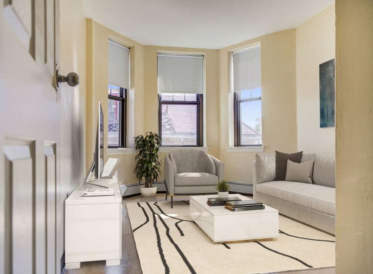 Plush carpeting living room at Blue Elm United Estates in Dorchester, Massachusetts