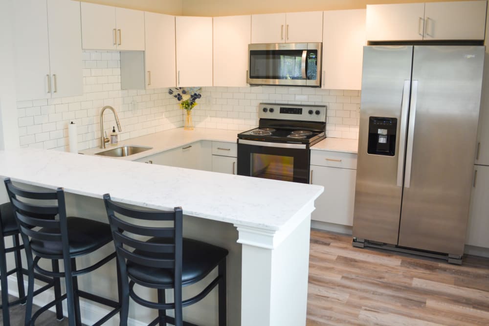 Kitchen with hardwood flooring at The Village at Voorhees in Voorhees, New Jersey