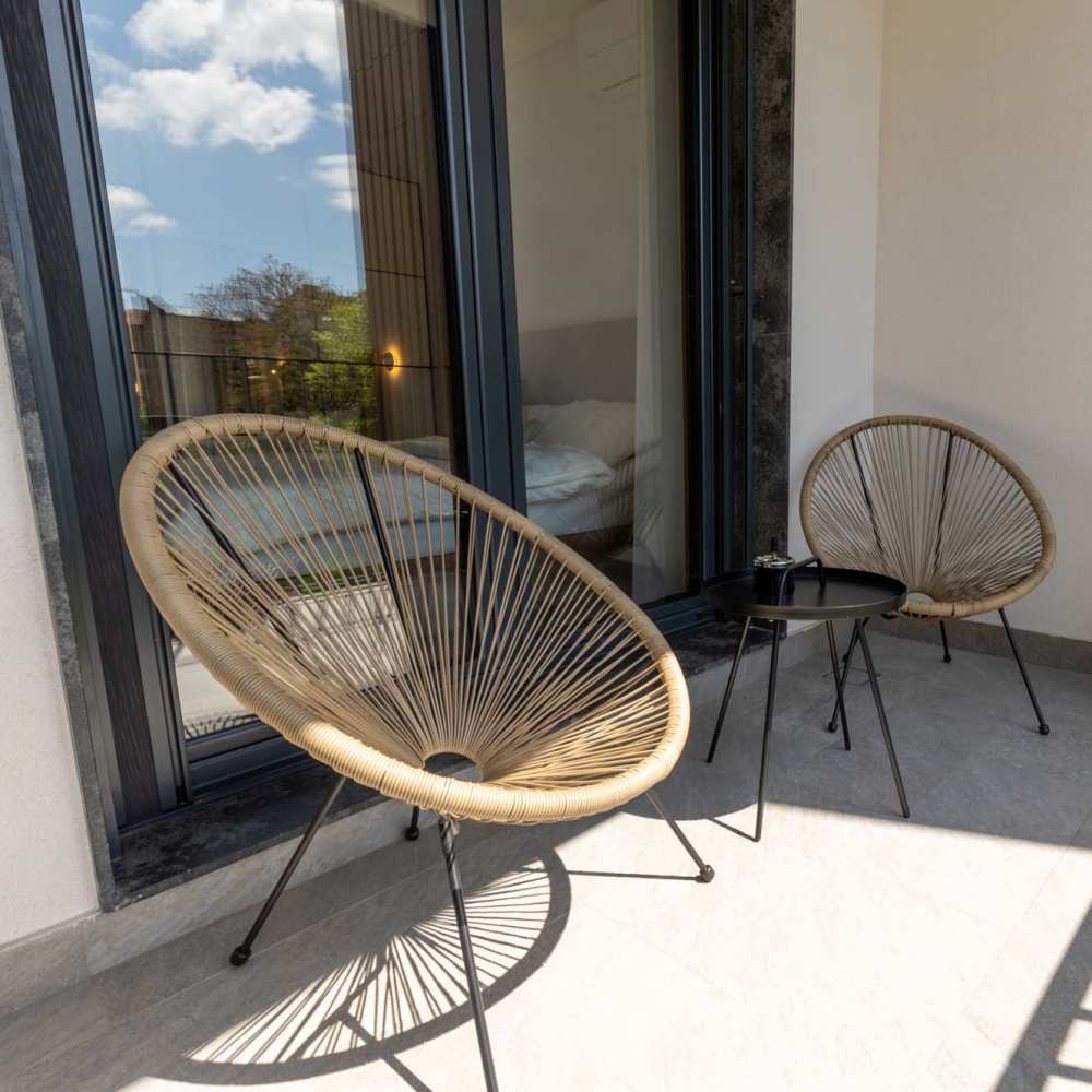Balcony with chairs and table at The Simone in Silver Spring, Maryland