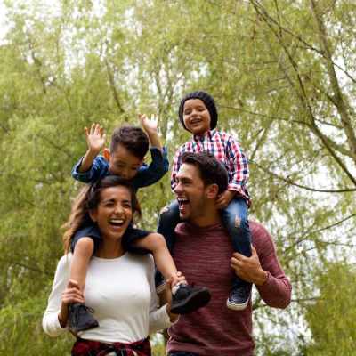 Resident family joyfully walks in the park near One Glastonbury Place in Glastonbury, Connecticut
