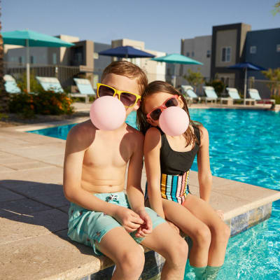 Kids blowing bubbles by the pool at BB Living at Civic Square in Goodyear, Arizona