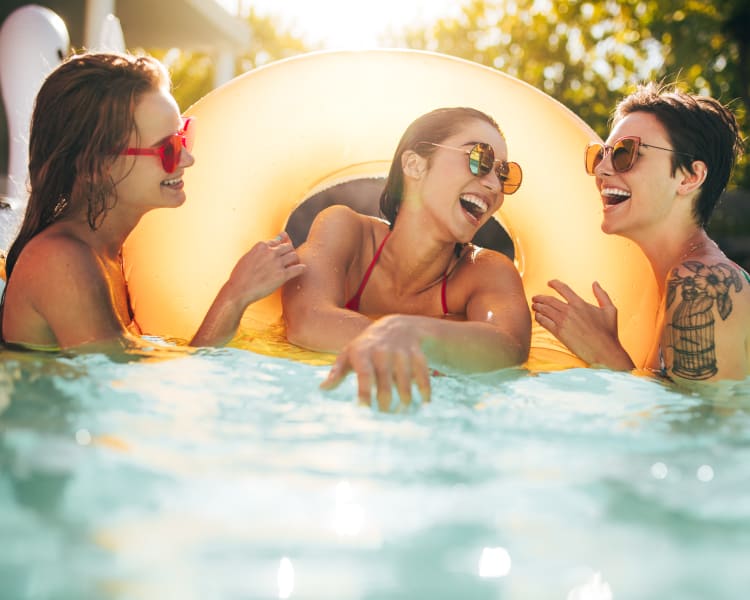 Resident lady friends having a blast in the pool at Canyon View in Las Vegas, Nevada